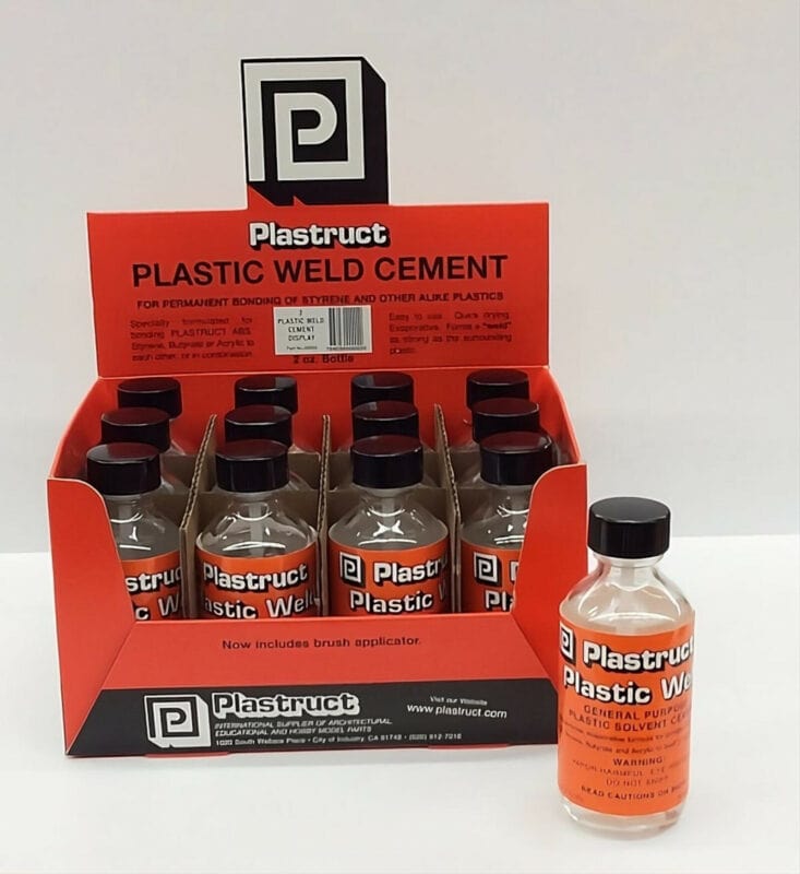 Several bottles of Plastruct plastic weld cement.