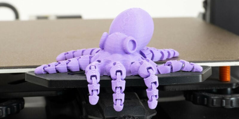 A purple 3D printed Octopus on a print bed to demonstrate the concept of Octoprint alternatives.