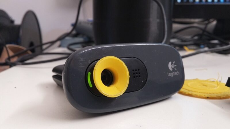 A Logitech C270 webcam with a 3D printed attachment.