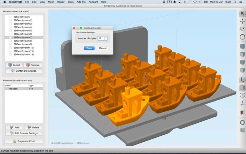 A photo of Simplify3D (not slicing on Android) with 12 benchy 3D models on its slicing plate.