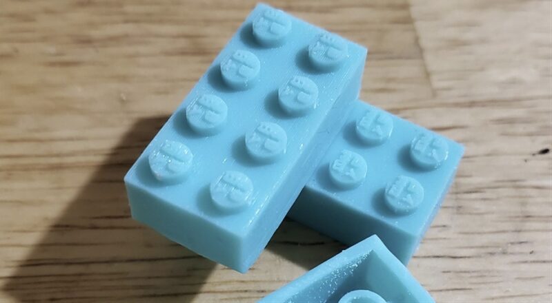 A set of blue ABS plastic 3D printed LEGO bricks.