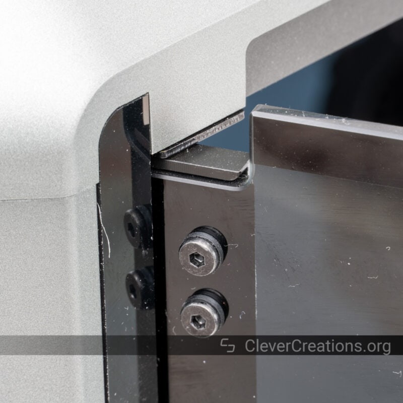 A close-up of a front door hinge on a 3D printer.