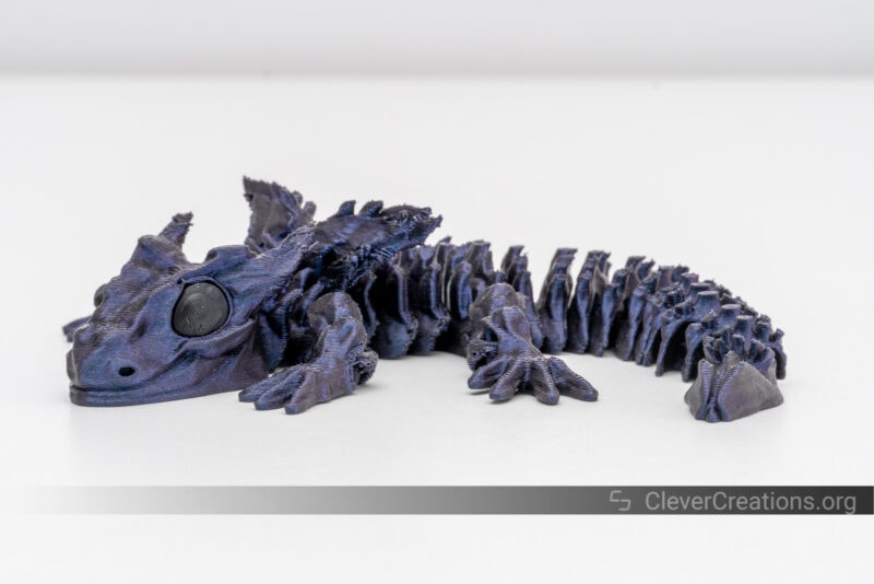 A 3D printed Glorious Baby Dragon in purple/blue PLA.