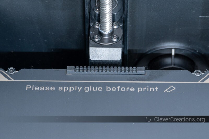 A nozzle wipe strip glued onto the rear of a print surface.
