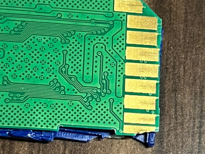 A SD card with clearly visible damage.