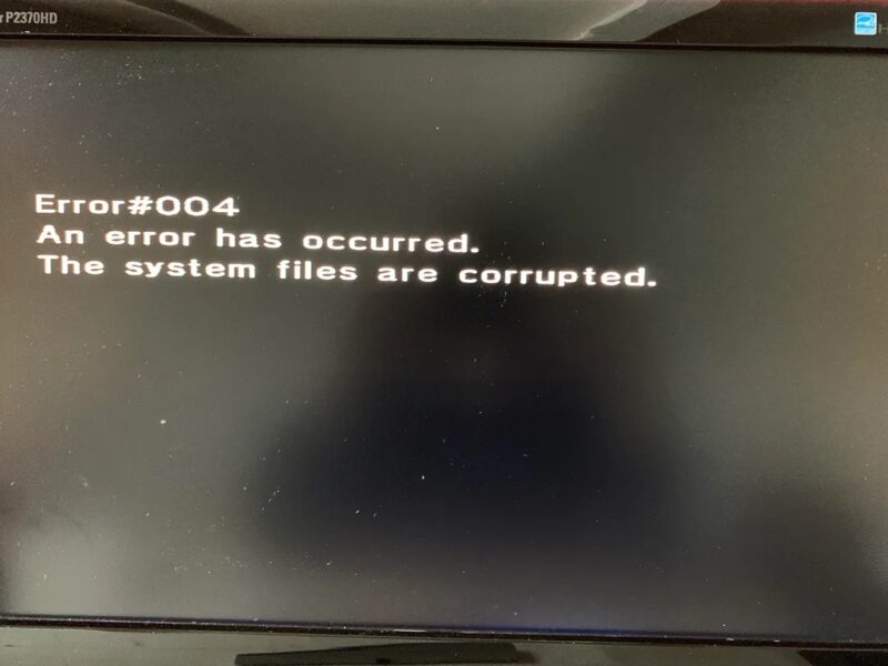 A monitor showing an SD card error message mentioning corrupted files.