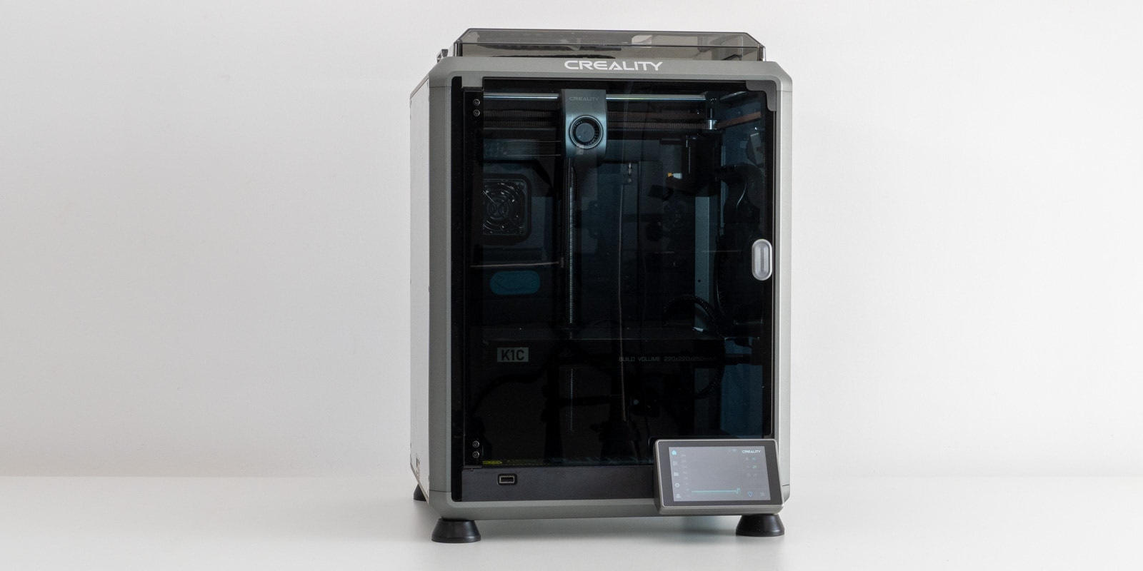 The Creality K1C 3D printer on a white table during a review.