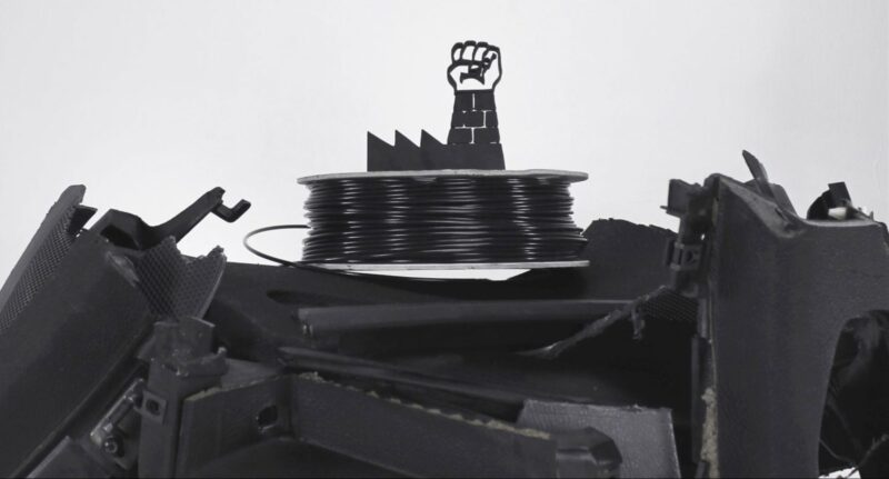 A spool of recycled ABS filament on top of a pile of 3D prints, answering the question "Is ABS Recyclable".