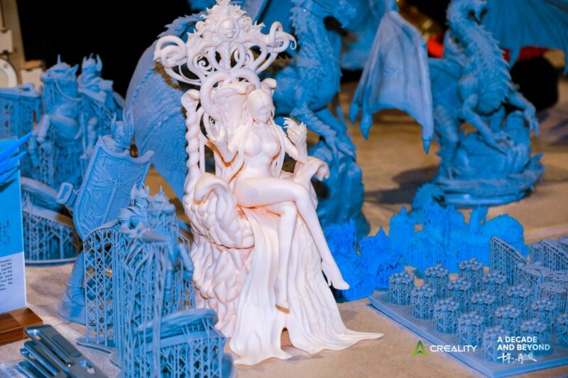 Several high-detail blue and white resin 3D prints.