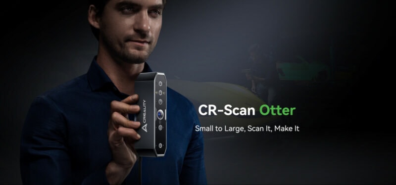 A man holding the CR-Scan Otter 3D scanner.