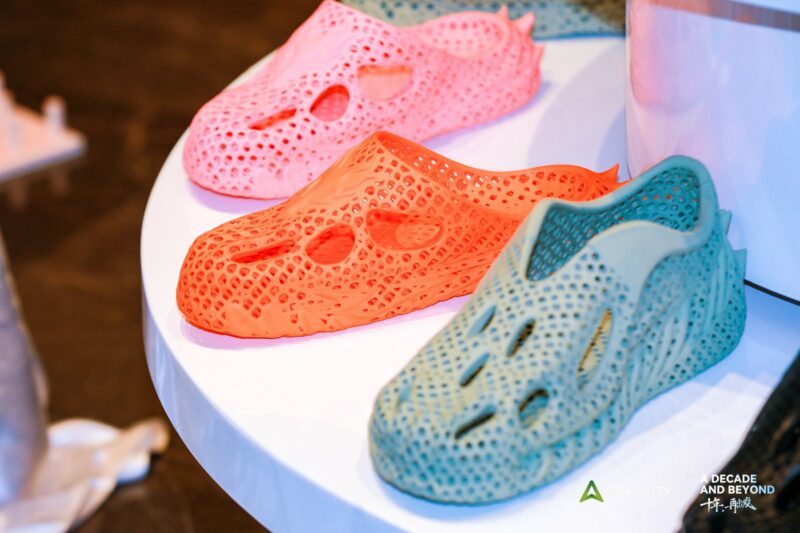 A collection of 3D printed shoes in various colors.