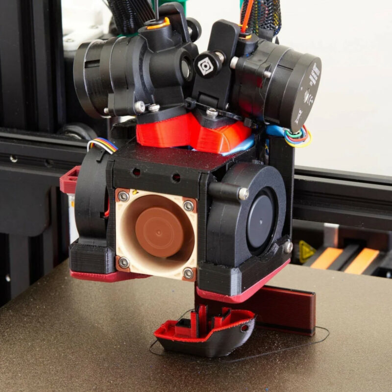A dual extruder/single nozzle 3D printer that has undergone a DIY conversion.