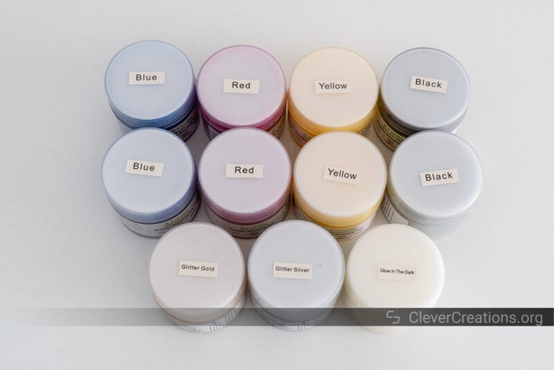 A collection of paints for screen printing (blue, red yellow, black, glitter gold, glitter silver, glow in the dark).